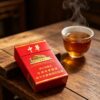 Chunghwa Hard Pack Chinese cigarette pack on wooden table beside hot tea cup premium red tobacco packaging lifestyle scene