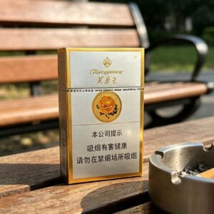 Furongwang White Pack Chinese cigarette pack on wooden table beside tea glass premium white and gold tobacco packaging