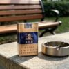 Yellow Crane Tower Blue Pack Chinese cigarette pack on wooden table with tea cup premium blue and gold tobacco packaging