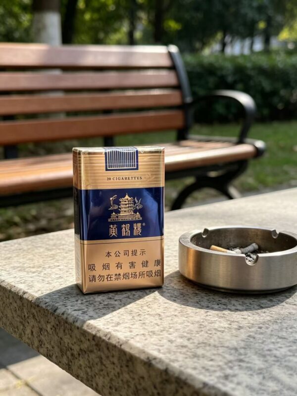 Yellow Crane Tower Blue Pack Chinese cigarette pack on wooden table with tea cup premium blue and gold tobacco packaging